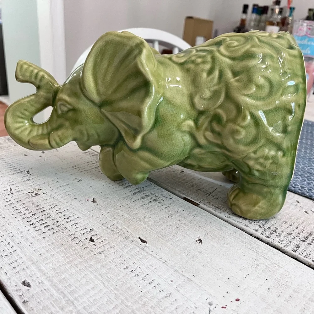 Elephant ceramic- Green Glaze Sitting with Floral Design 10 1/2” euc